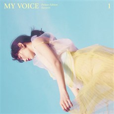 Taeyeon's 'My Voice Deluxe Edition' album cover, featuring her elegant portrait with soft pastel tones, accompanied by a premium package design and additional tracks.